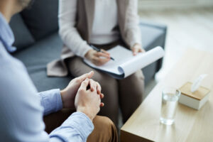 Crossed hands of patient and counselor